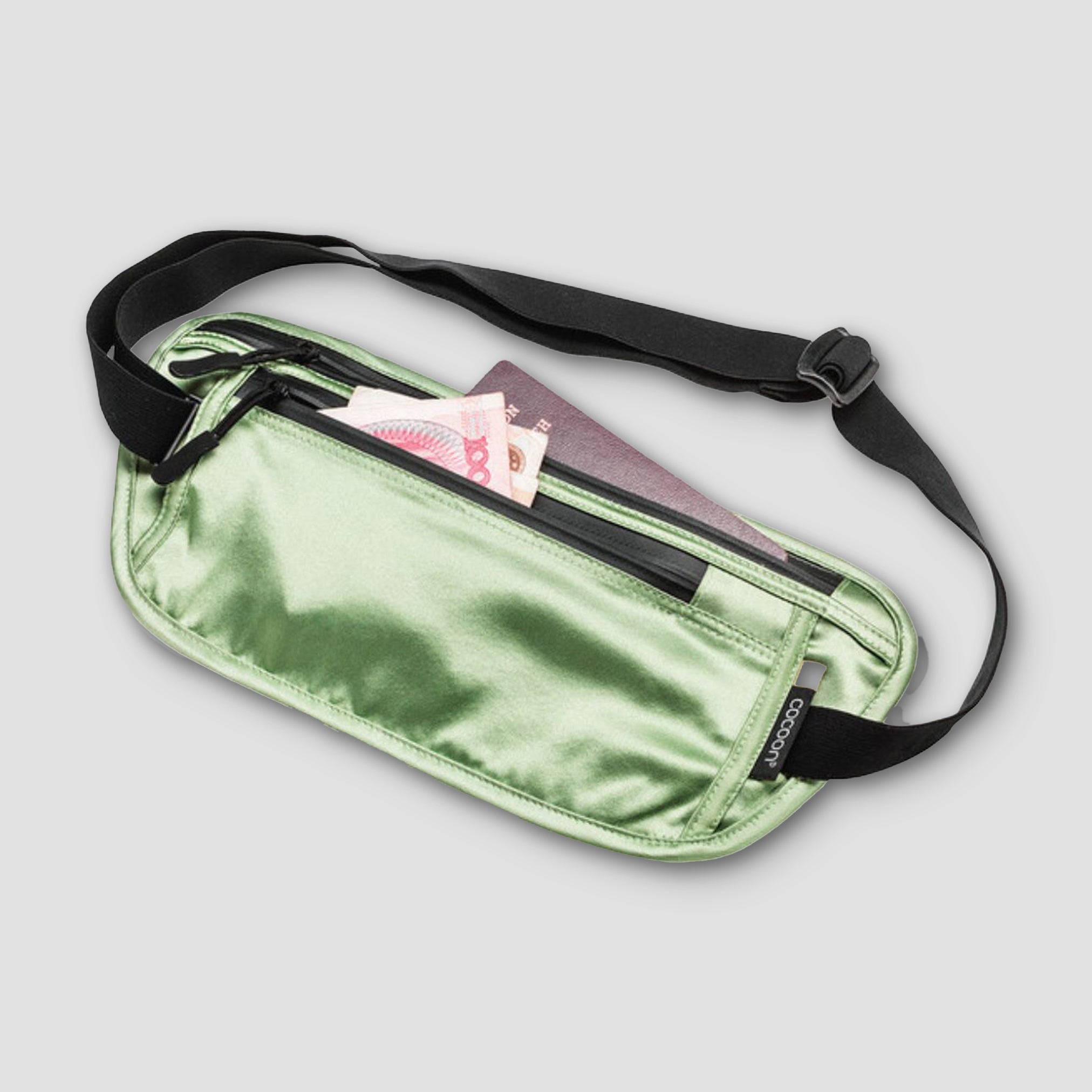 Green metallic fanny pack with a black strap on a light gray background