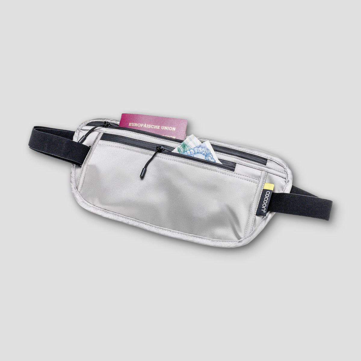 Silver waist bag with a black strap on a light gray background