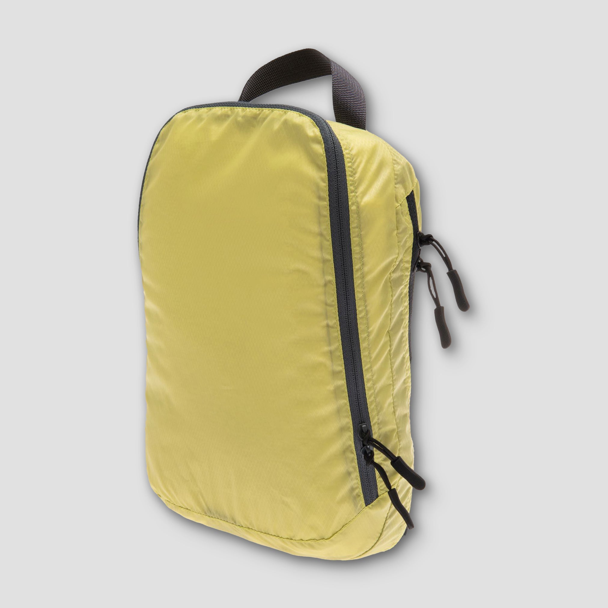 Yellow backpack with black zippers on a light gray background