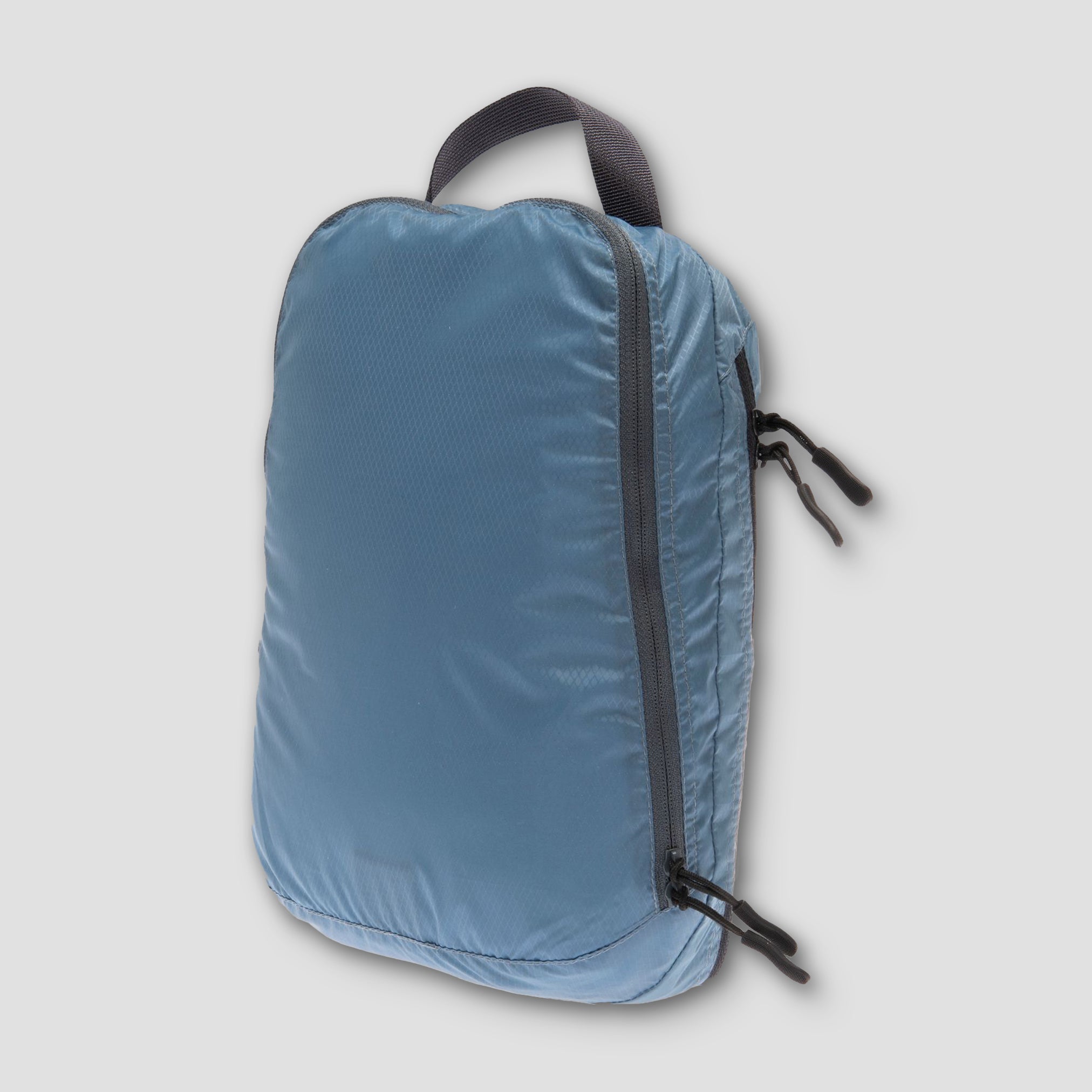 Blue backpack with a black zipper on a light gray background
