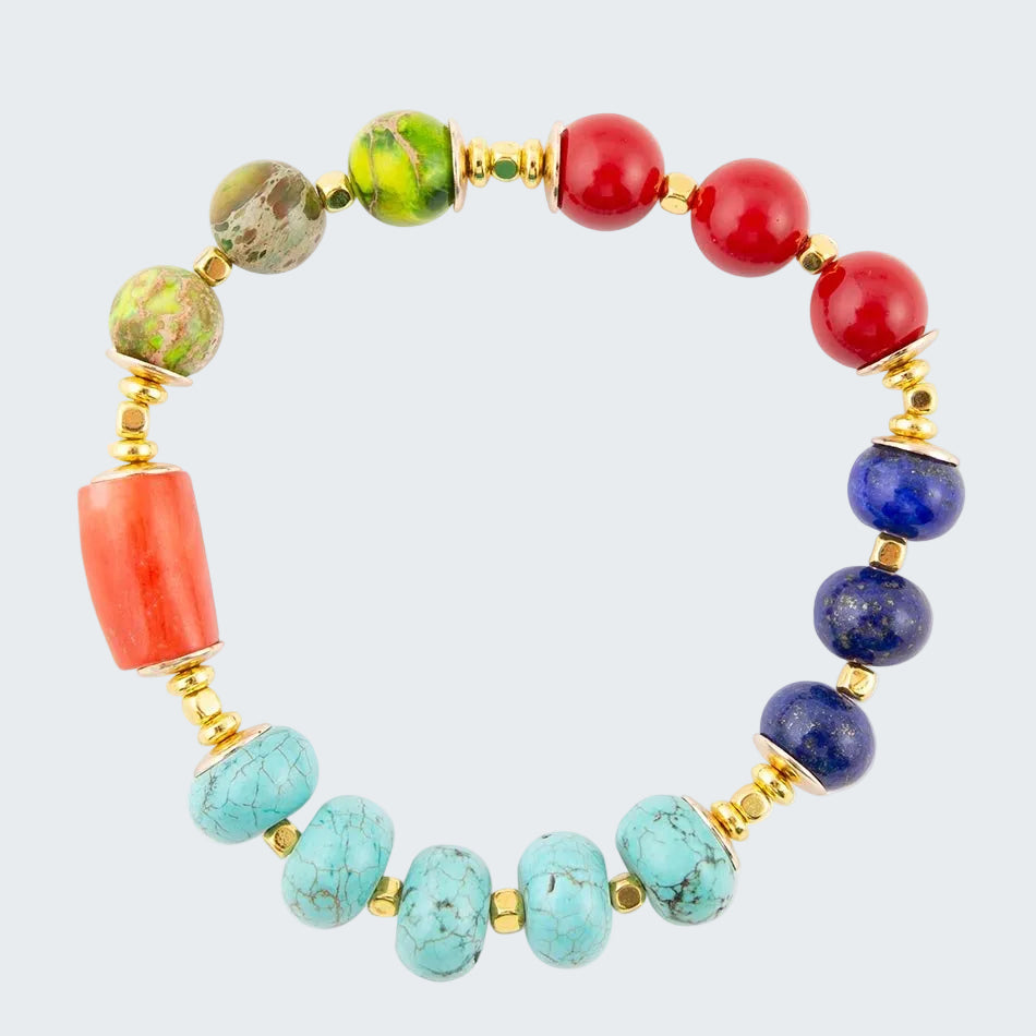 Multicolored beaded bracelet with gold accents on a white background